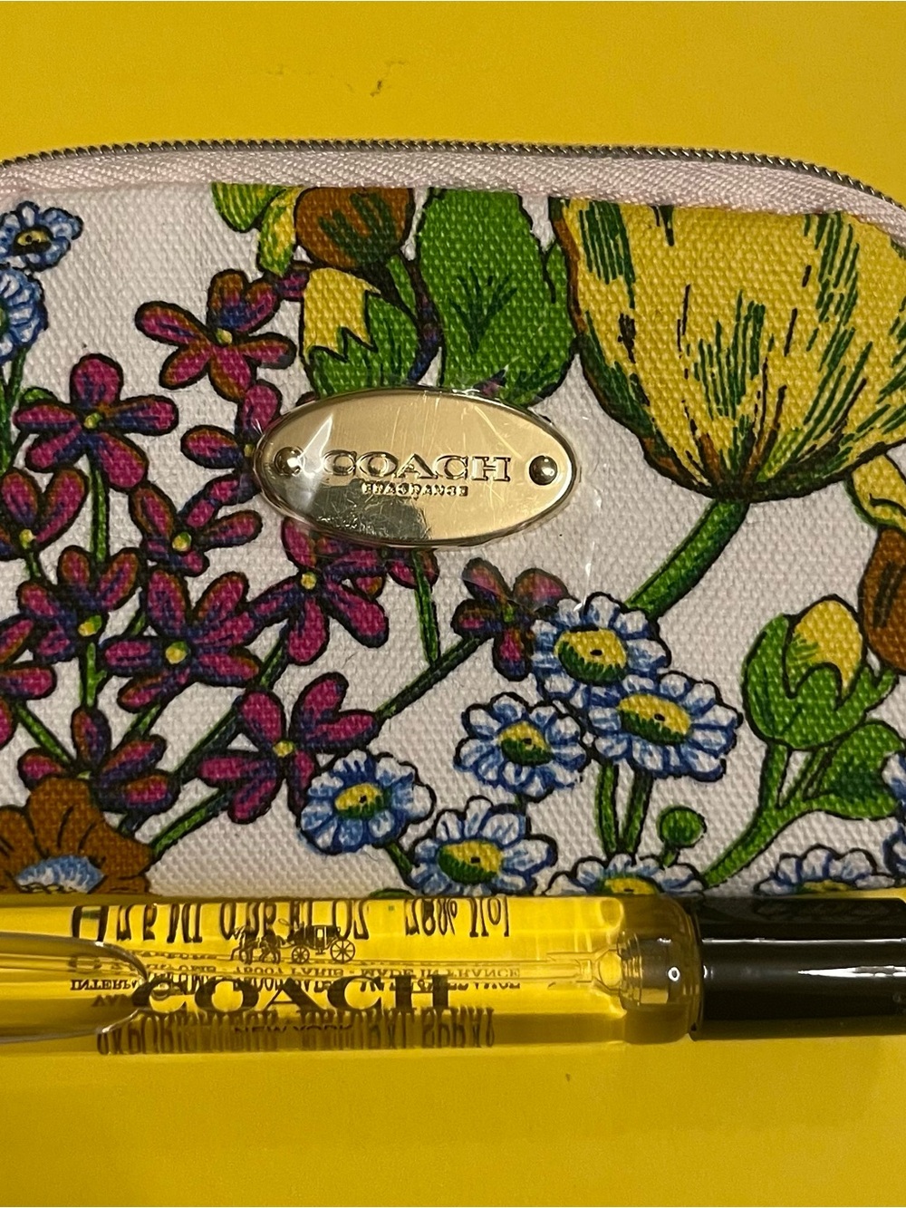 Coach perfume and floral Zip case.